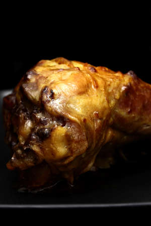 Lamb shank on a black plate and backgroundの写真素材