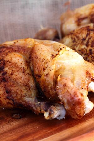 Roast chicken thigh on a wooden chopping boardの写真素材