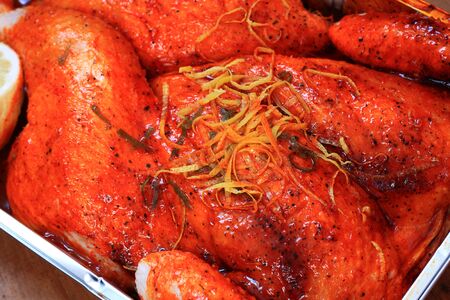 Chicken with a Piri Piri marinade in a baking trayの写真素材