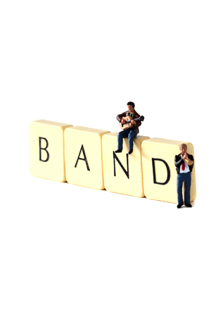 Scale model miniature musicians with the word band on tiles.の写真素材