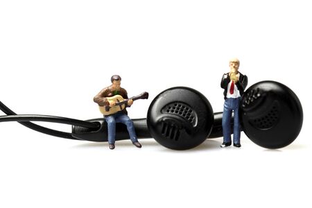Miniature scale model musicians on earphonesの写真素材