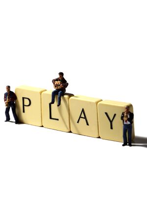 Scale model miniature musicians with the word play on tiles.の写真素材