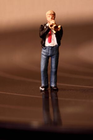 Miniature scale model musician on a vinyl recordの写真素材