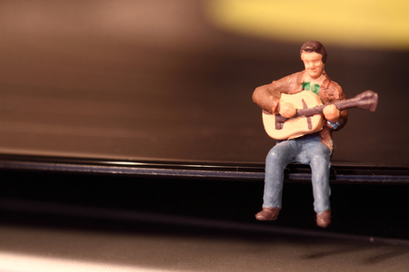 Scale model miniature musician performing on a vinyl record.の写真素材