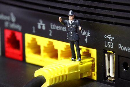 Miniature scale model police officer standing on a router