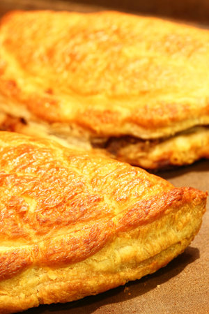 Freshly baked Cornish pasties on a baking tray