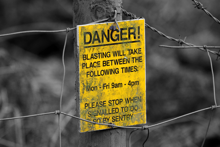 Selective colour image of a danger explosives signの写真素材
