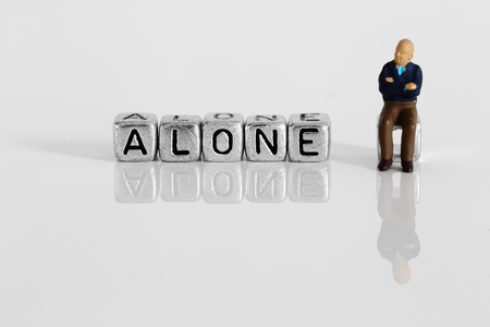 Miniature scale model pensioner with the word alone on beadsの写真素材