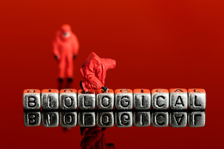 Miniature scale model team in chemical suits with the word biological on beadsの写真素材