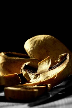 Sliced mushroom with knife on wood with selective colorの写真素材