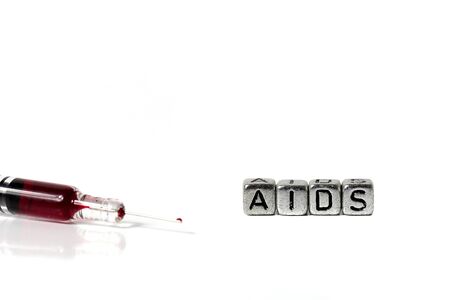 Syringe and blood with the word aids on beadsの写真素材