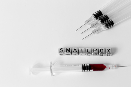 Syringes and blood with the word Smallpox on beadsの写真素材