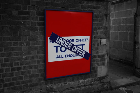 To let under offer sign for an office on a brick wall with selective colorの写真素材