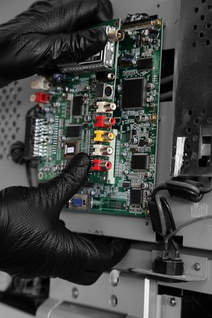 Man connecting a circuit board on a flat screen televisionの写真素材