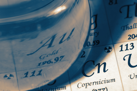 Chemicals in glass laboratory flask on the periodic table chart with colour toningの写真素材