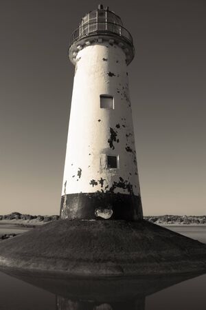 Point of Ayr lighthouse on a beach in North Wales.  With sepia colour toningの写真素材