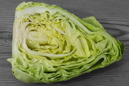 Spring cabbage sliced cross-section on a grey wood backgroundの写真素材