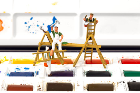 Miniature scale model painters decorators on a watercolour palette set.  Painting decorating conceptの写真素材