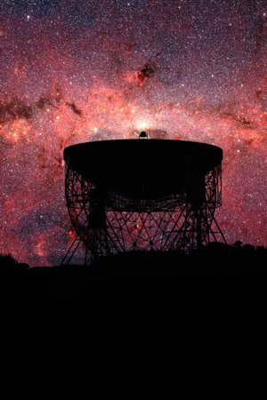 Radio telescope dish silhouette at night with the Milky Way stars in the background.  Astrophysics...