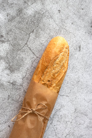 Baguette bread, french stick, wrapped in brown paper tied with string.  Recycle packaging conceptの写真素材