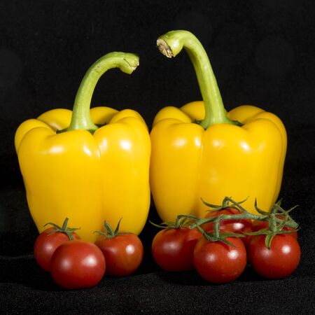 Two peppers prepare to enter the kitchen With Their tomatoes, to prepare a delicious Italian dish with pasta.の写真素材