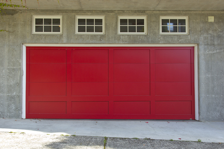 Large red garage door and four windows の写真素材