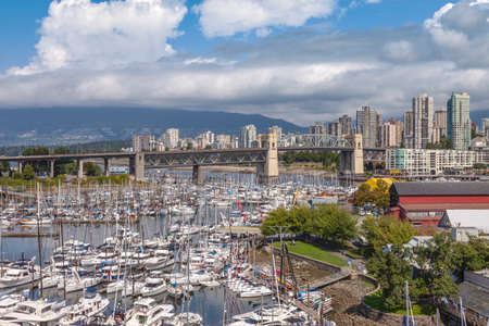 Large boat sales in Granville island and Vancouver BC skyline Canada.のeditorial素材