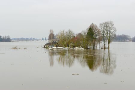 Flood in spring surrounding a countryside house の写真素材