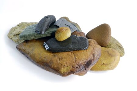 Stack of wet multicolored pebble on white backgroundの写真素材