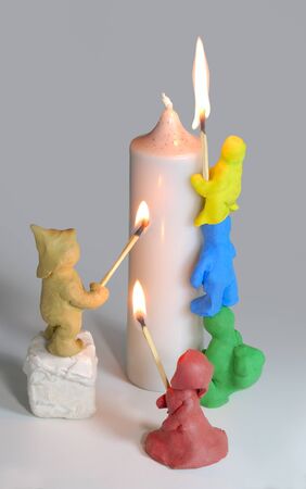 Plasticine puppet and candleの写真素材