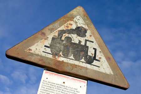 a old railroad sign with a black train on it  の写真素材