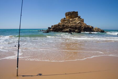 a rock and fishing rodの写真素材
