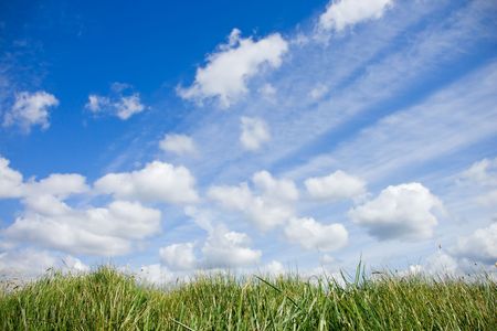 Sky With Clouds And Green Grassの写真素材