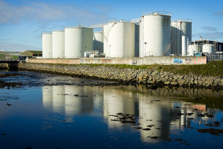 Fuel Tanks On The Bank Of The River
