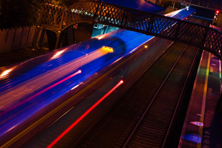 blurred train in motion with lights arriving to the station at  night の写真素材