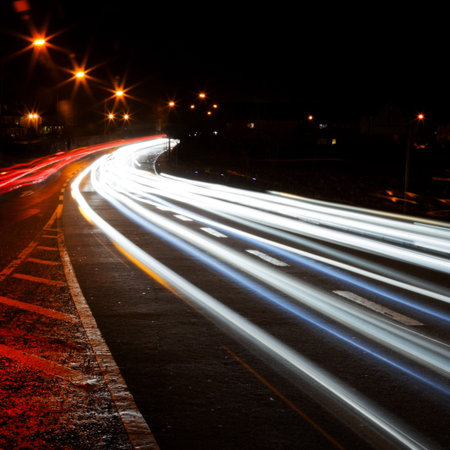 car lights trails and road marks at night city street