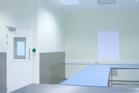 clean room with tables in medical packaging plant interiorの写真素材
