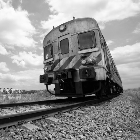 Passenger train in motion and sky with clouds, Monochromaticの写真素材