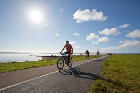 GALWAY, IRELAND - OCTOBER 6: Pauline Curley (3827), lead woman, escorted with race marshal, compete during annual Galway Bay Half Marathon and 10K, on October 6, 2012 in Galway, Ireland.のeditorial素材