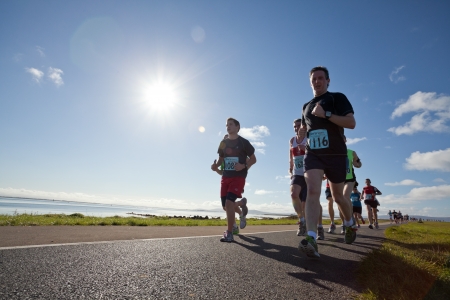 GALWAY, IRELAND - OCTOBER 6: Liam Collins (1116) and other athletes compete during annual Galway Bay Half Marathon and 10K, on October 6, 2012 in Galway, Ireland.のeditorial素材