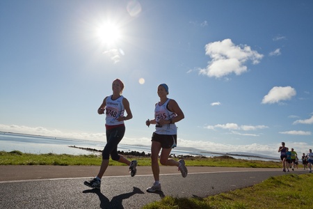 GALWAY, IRELAND - OCTOBER 6: Siobhan Moore (3748) and other athletes compete during annual Galway Bay Half Marathon and 10K, on October 6, 2012 in Galway, Ireland.のeditorial素材