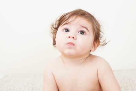 Portrait of Cute baby boy sitting on the blanketの写真素材