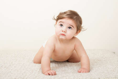 Cute Baby boy crawling on knitted blanketの写真素材