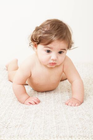 Cute Baby boy crawling on knitted blanketの写真素材