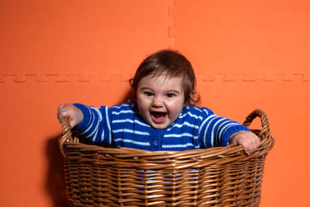Portrait of Cute baby boy having fun in the basketの写真素材