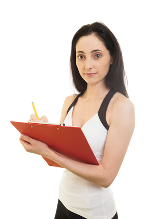 Female Fitness trainer with paper, making Workout Planの写真素材