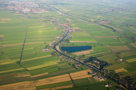 Aerial view over the Amsterdam suburbs with canals, houses and fields. Hollandの写真素材