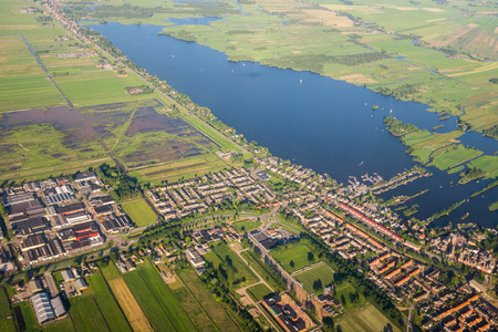 Aerial view over the Amsterdam suburbs with canals, houses fields and lake. Hollandの写真素材