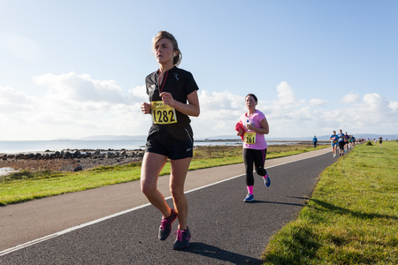 GALWAY, IRELAND - OCTOBER 4: Unidentified athletes compete during annual Galway Bay Half Marathon and 10K, on October 4, 2014 in Galway, Ireland.のeditorial素材