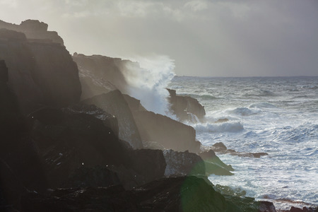 Big waves breaking on cliffs during winter storm on the west coast of Ireland.の写真素材